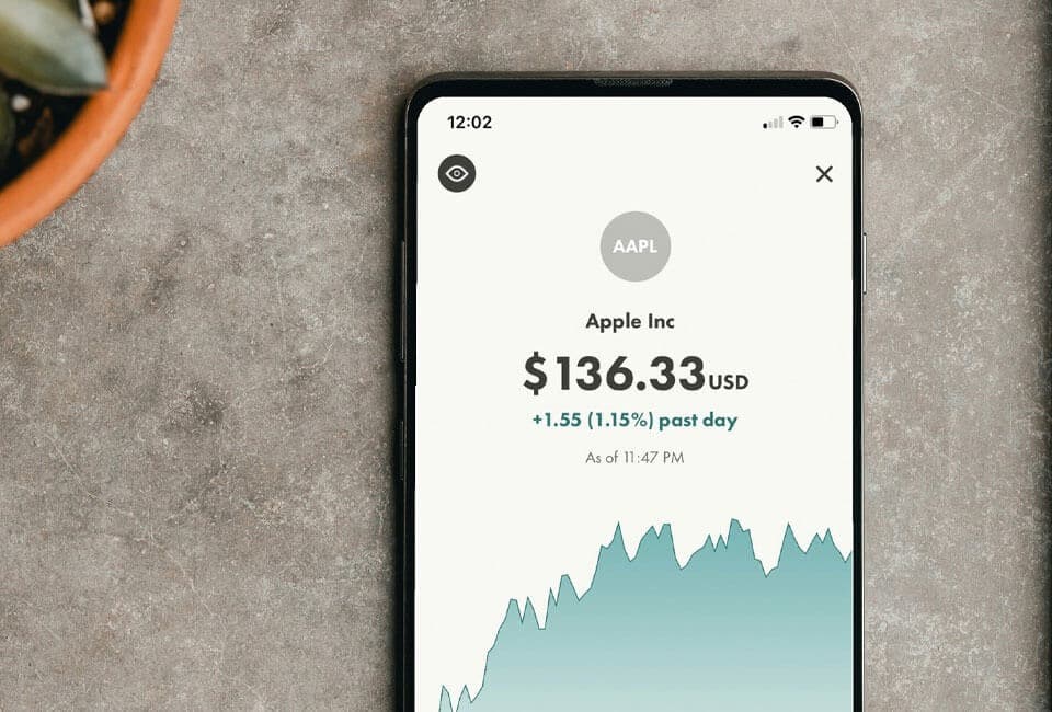 A smartphone displaying stock market data for Apple Inc. (AAPL)